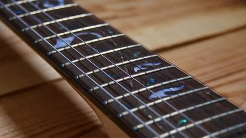 Camera glides parallel to the guitar neck; Stock-Footage 79819585