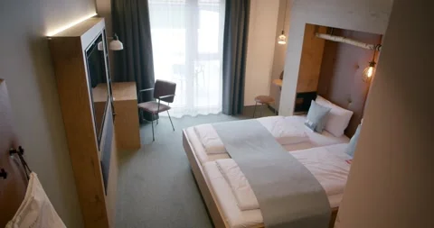 Camera Glides Past Mirror To Reveal Full Hotel Room With Beds Vídeo Stock 340265427