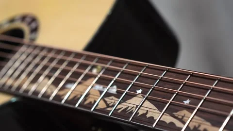 The camera glides slowly along the guitar neck Stock Footage 266751193