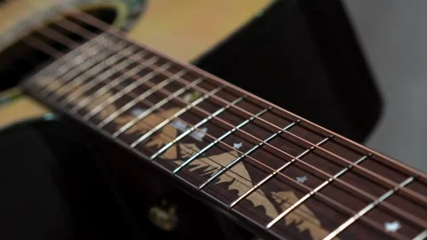The camera glides slowly along the guitar neck Stock Footage 266751207