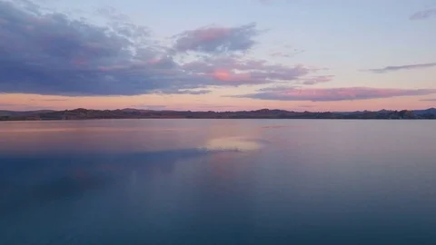 Camera gliding over water surface, beautiful shot of sunset Stock Footage 78591904