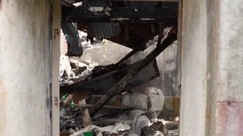 Camera gliding through the doorway of a collapsed structure Stock Footage 293159254