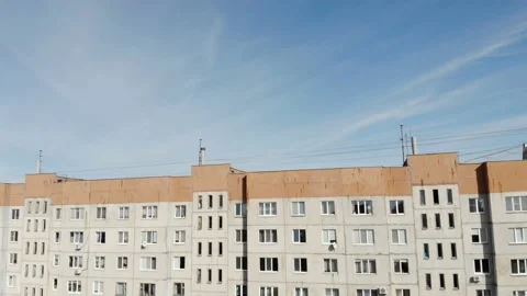 The camera goes down in front of the wall of the building with a huge number of Stock Footage 96345840