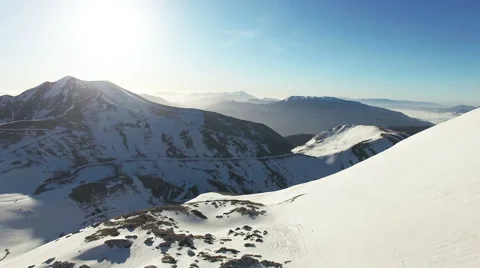 The camera goes over the mountains with snow. Aerial drone video. N. Stock Footage 63431546