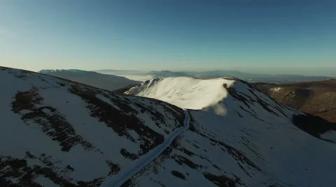 The camera goes over the snowy mountains. The camera goes on. Aerial  video. N Stock Footage 63473674