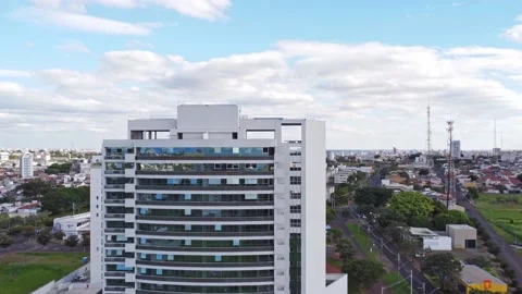 Camera going up in front of the office building revealing the city Stock Footage 239269440