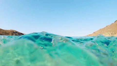 Camera going underwater under the surface of the ways in crystal clear sea 스톡 동영상 221991379