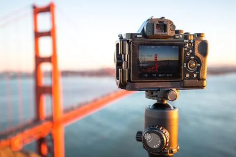 Camera with gold gate bridge over water Stock Photos