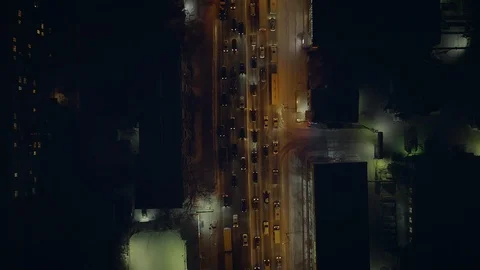 The camera gradually floats on the night road with slow cars with headlights on. Stock Footage 113816540