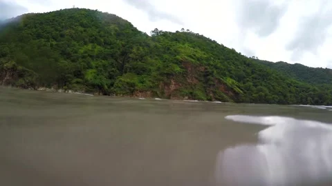 Camera half in under water in the mountain river bank Stock Footage 220407115