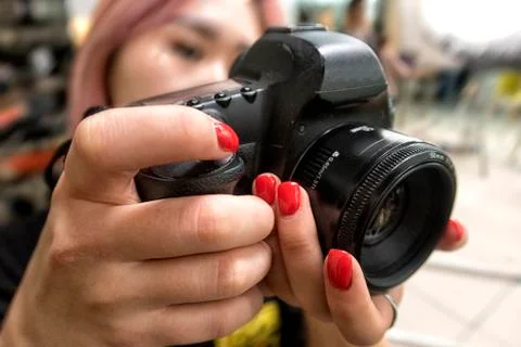 The camera is in the hands of the photographer. Stock Photos