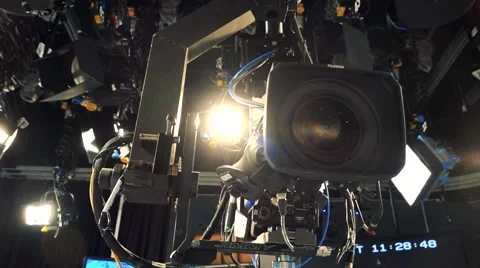Camera hangs on ceiling and spotlight shines in television studio Stock Footage