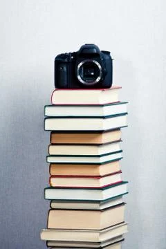 Camera on a high stack of books Stock Photos