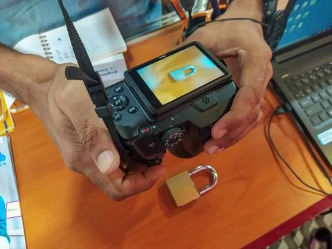 Camera holding hand trying to capture an object Foto stock