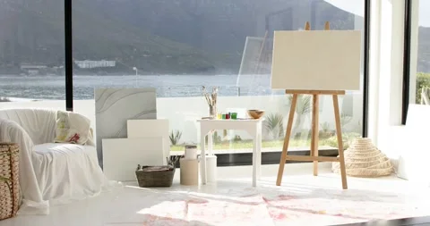 Camera holding steady view of studio corner with easel and supplies beside 库存影片 340069420