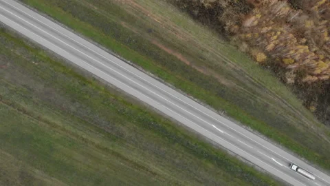 The camera hung at a high altitude above the road passing diagonally. Stock Footage 99966705