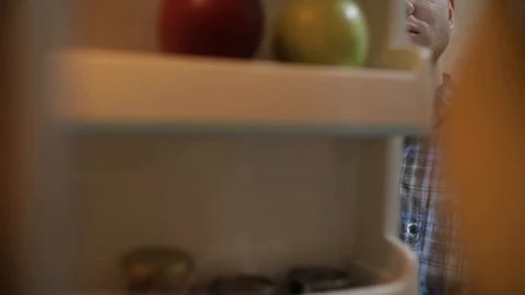 Camera inside the kitchen refrigerator. A handsome young developer on isolation Stock Footage 129152641