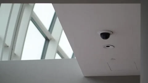 A camera is installed on the ceiling near windows Stock Footage 344513673