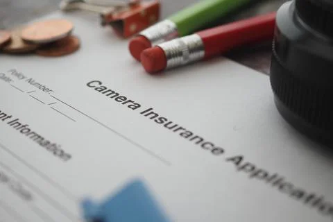 Camera insurance application form on a table Stockfoto's