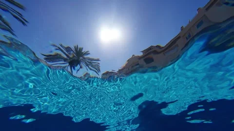 Camera jumping in and out of pool water in housing urbanization Stock Footage 338228039