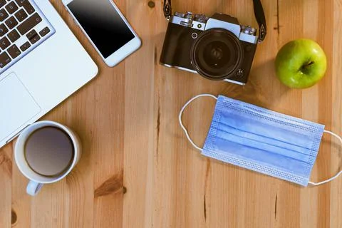 Camera, a laptop computer, a smart phone, an apple, a facial medical mask and Foto stock