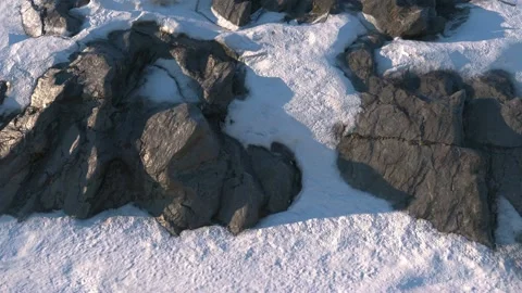 Camera from left to right studies the slope of the snow-covered mountain. Blue Stock Footage 148383502
