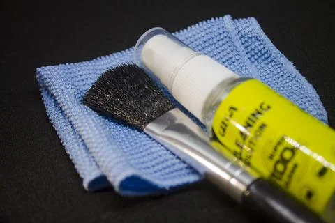 Camera lens cleaning kit. Camera lens cleaning liquid with microfibre and bru Stock Photos