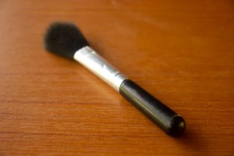 Camera lens cleaning pen placed on brown table Foto stock