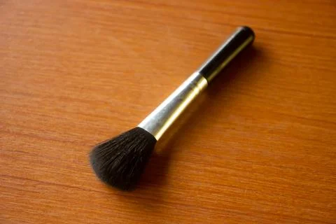 Camera lens cleaning pen placed on brown table Stock Photos