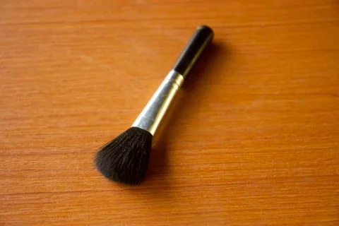 Camera lens cleaning pen placed on brown table Stock Photos