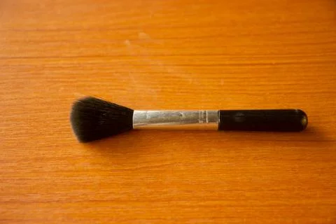 Camera lens cleaning pen placed on brown table Stock Photos