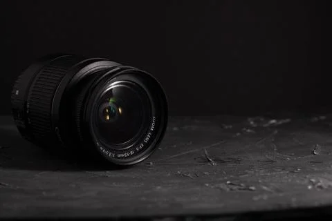 Camera lens on a dark background. Black background Stock Photos