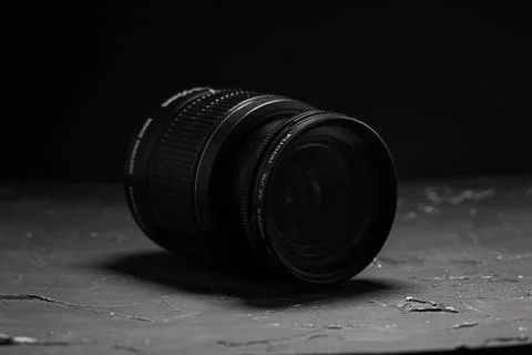 Camera lens on a dark background. Black background Stock Photos