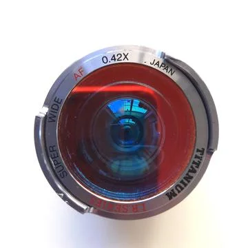 A camera lens featuring textured focus rings, red accent band Stock Photos