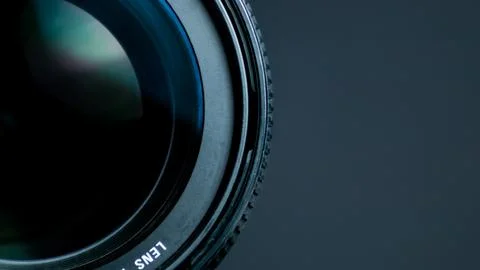Camera lens on a gray background. Shallow depth of field. Stock Photos