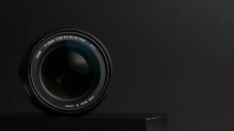 Camera lens on a gray background. Shallow depth of field. Stock Photos