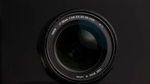 Camera lens on a gray background. Shallow depth of field. Stock Photos