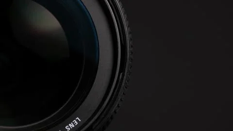 Camera lens on a gray background. Shallow depth of field. Stock Photos