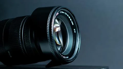 Camera lens on a gray background. Shallow depth of field. Stock Photos