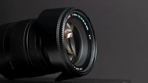 Camera lens on a gray background. Shallow depth of field. Foto stock
