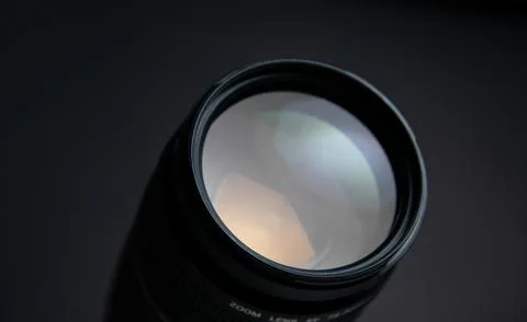 Camera lens on a gray background. Shallow depth of field. Stock Photos