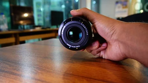 Camera lens in hand Stock Footage 320316493