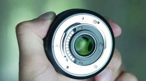 Camera Lens In Hands Stockbeeldmateriaal 67496615