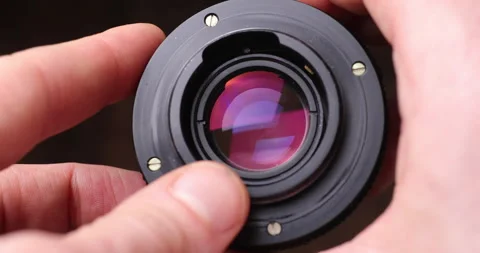 Camera lens holding in hands Stock Footage 156858302