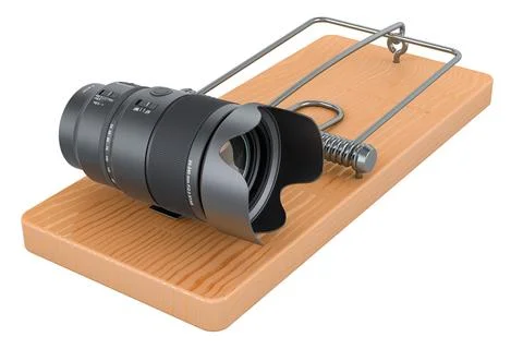 Camera lens inside mousetrap. 3D rendering Stock Illustration
