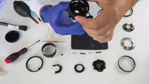 Camera lens repair by master. Repairing photographic equipment and accessories Stock Footage