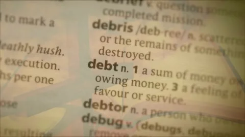 Camera lens shifting focus on text column, bringing debt into view with ghosted Stock Footage 330461838
