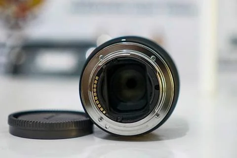Camera lens on table with blurred background Stock Photos
