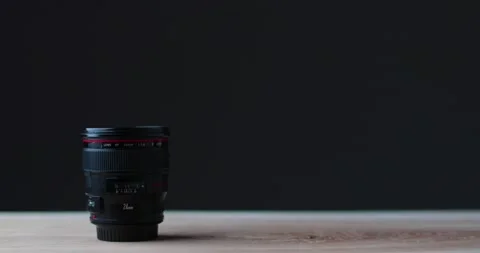 Camera lens on white studio table with black background quality camera equipment Stock Footage 237546519