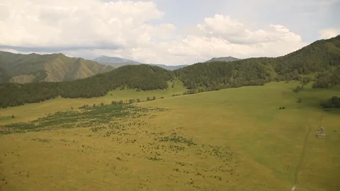 The camera in a light-engine plane flies in the mountains. 動画素材 119995638